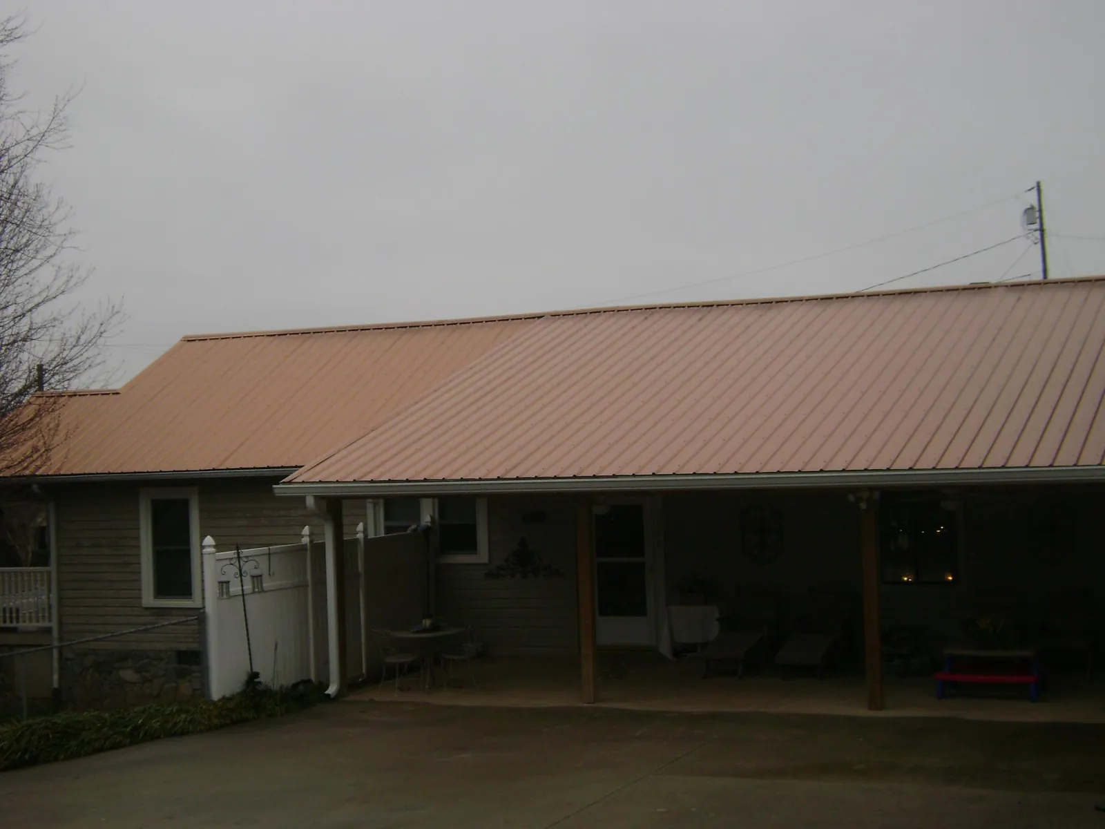 Copper toned metal roof over a wide covered patio in Hillsboro